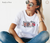 Model showcasing vibrant 'Jesus, His love is strong' DTF transfer on white tee | LuxuryDTF
