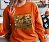 Model wearing an orange t-shirt with a "Just Waiting for Halloween" skeleton DTF transfer design.