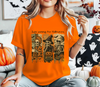 Woman in an orange sweatshirt featuring a retro three-skeleton Halloween DTF transfer print.