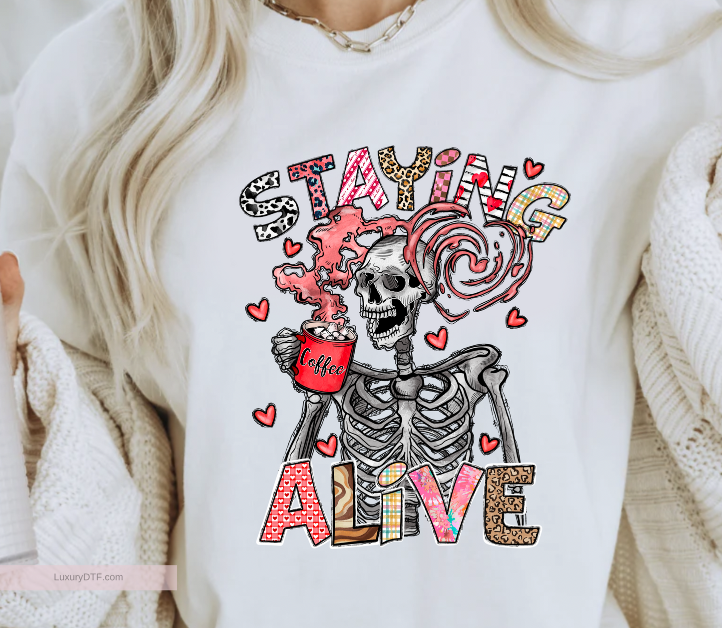 Funny illustration skeleton design with colorful text "Staying Alive" drinking his/her favorite coffee, with vapor in a shape of heart. DTF transfer ready to press, screen print transfer | Luxurydtf.com