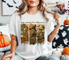 Woman wearing a white t-shirt showcasing a "Just Waiting for Halloween" skeleton friends DTF transfer.